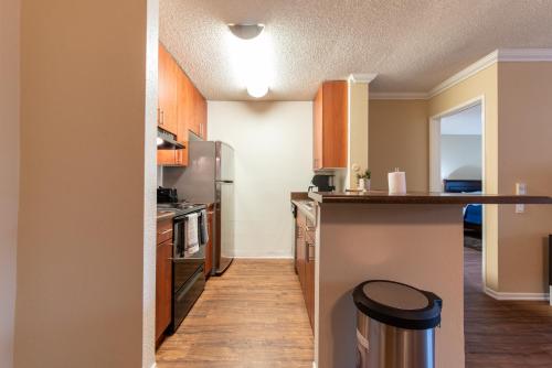 a kitchen with wooden cabinets and a counter top at Luxurious stay near the beach in Newport Beach