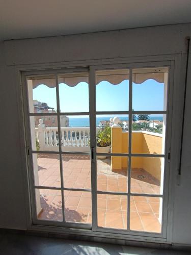 an open door with a view of a balcony at LOVELY PENTHOUSE in front of the beach with free parking in Málaga