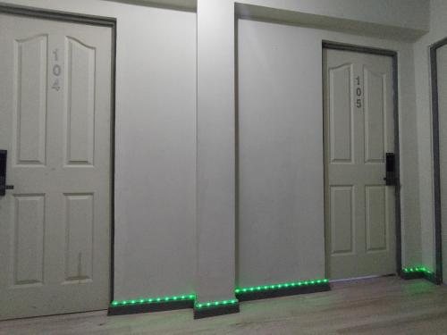 a room with two doors with green lights on them at Costanera Bed & Breakfast in Santiago