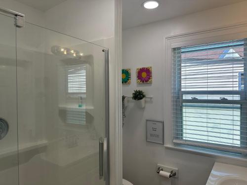 a bathroom with a shower and a toilet and a window at Cozy Private bedrooms Kitchen Wifi in Englewood