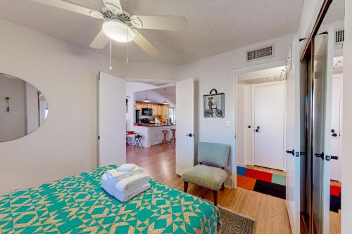 a bedroom with a bed and a ceiling fan at Desert Blooms in Avondale