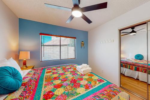 a bedroom with a bed and a ceiling fan at Desert Blooms in Avondale