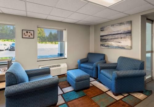 a waiting room with blue chairs and a window at Best Western Adena Inn in Chillicothe