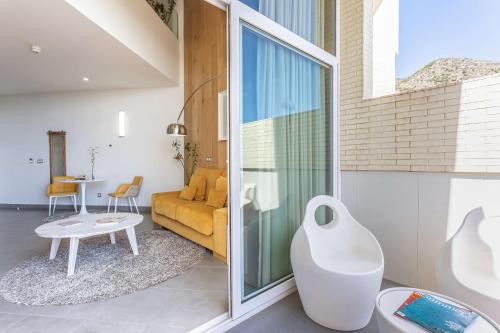 a living room with a couch and a table at Higuerón Hotel Curio Collection by Hilton in Fuengirola