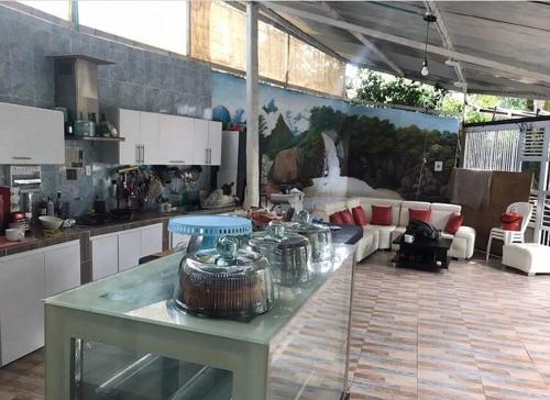 a kitchen with a table with a pot on it at Hotel Ambrosia Lodge in Rivera