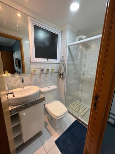 a bathroom with a toilet and a sink and a shower at Flat Palm village in Porto De Galinhas