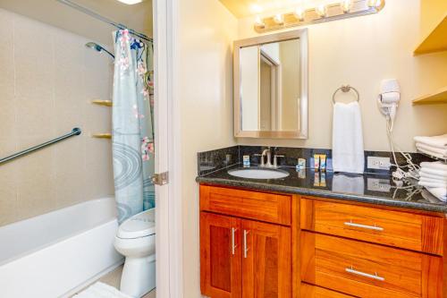 a bathroom with a sink and a toilet and a mirror at Mountain View Condo Near Beach with Free Parking! in Honolulu