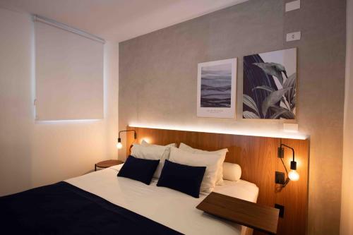a bedroom with a large bed with black and white pillows at Leblon Design Hotel in Rio de Janeiro
