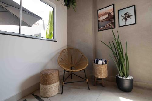 a room with a chair and a plant and a window at Leblon Design Hotel in Rio de Janeiro