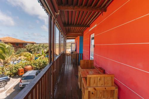 a balcony of a house with a bench on it at Nos Krusero Apartments in Sabana Westpunt