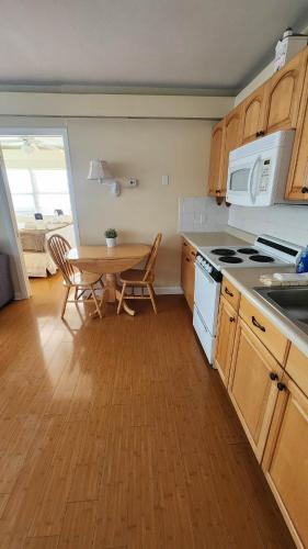 a kitchen with a table and a table and chairs at By the Beach Rentals in Clearwater Beach
