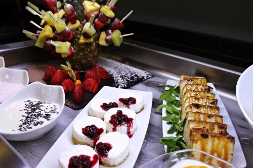 a buffet of food with desserts and fruit at DWO Urban Granada in Granada