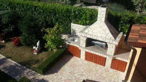 a model of a garden with a stone fireplace at Apartment Zdravko in Štinjan