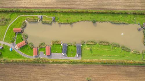 an overhead view of a park with a road and grass at Lakeside Fishing Cabins in Boston