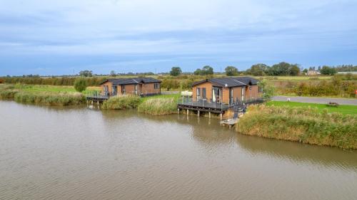 an aerial view of a row of houses next to a river at Lakeside Fishing Cabins in Boston