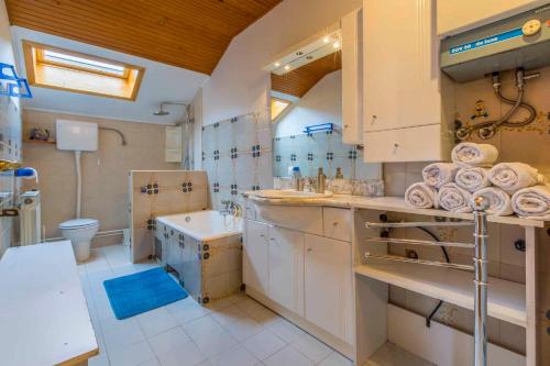 a large bathroom with a sink and a toilet at Apartment in Tribalj 33528 in Tribalj