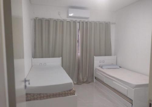 Katil atau katil-katil dalam bilik di Casa de Praia da Lara
