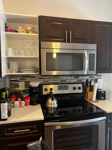 a kitchen with a stove and a microwave at Modern comfort at The Domain Austin ,Texas in Austin