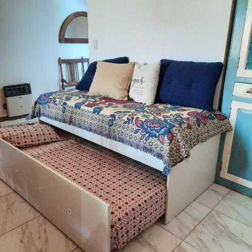 a bed with pillows on it in a room at Inocencia Faez in Roldán