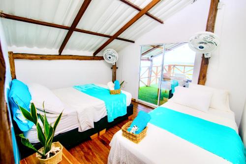 two beds in a room with a window at Solarium Beach Club in Playa Blanca