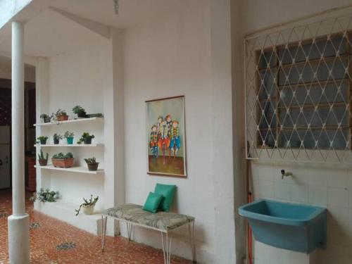 a bathroom with a blue sink in a room at Cantinho da Vovó Regina in Miguel Pereira