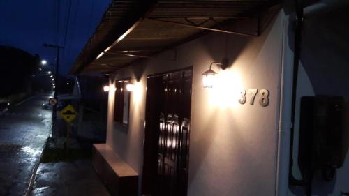 a building with lights on the side of it at night at Pousada Vino & Leta O seu parador no centro in Grão Pará