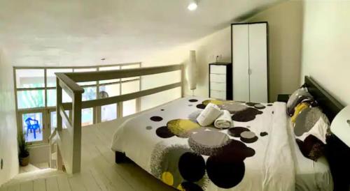 a bedroom with a bed with a black and white comforter at Paradis Mimies Dominican Bay in Boca Chica