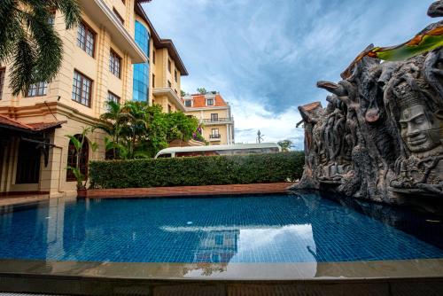 a large swimming pool in front of a building at Royal Crown Hotel & Spa in Siem Reap