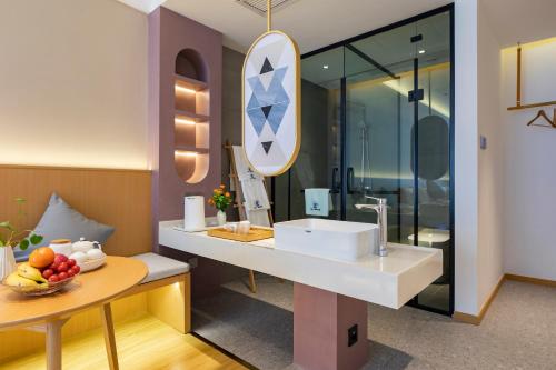 a bathroom with a sink and a mirror at Mount Huangshan Yunqi Kinship B&B - Huangshan Mountain Scenic Area Tangkou South Gate Interchange Center in Huangshan City