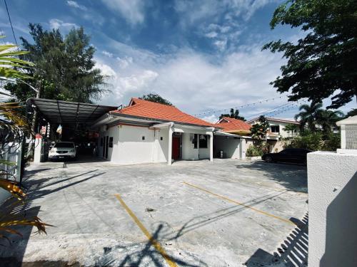 a house with a parking lot in front of it at Ardour Lodge "B" Wing in George Town