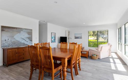 a dining room with a wooden table and chairs at Great Family Holiday House in Central Location in Victor Harbor
