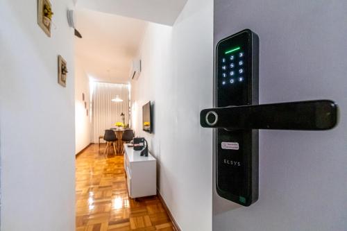 a door sensor on a wall next to a room at Vinicius de Moraes Ipanema Apartment in Rio de Janeiro