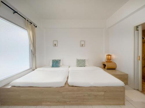 Ένα ή περισσότερα κρεβάτια σε δωμάτιο στο Chiangmai Inn Guesthouse