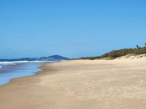 a sandy beach with the ocean in the background at Sun, sand, and surf, Sunrise Beach in Sunrise Beach
