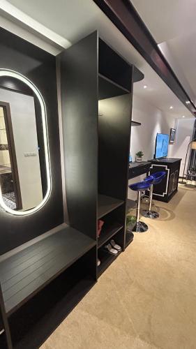 an office with a desk and a mirror in a room at Mango Hotel - Ha Noi Railway station in Hanoi