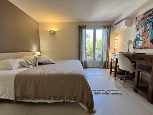 a bedroom with a bed and a desk and a desk at Villa de Luxe 4 Chambres avec Piscine Chauffée et Aménagements Haut de Gamme, La Croix-Valmer - FR-1-726-32 in La Croix-Valmer