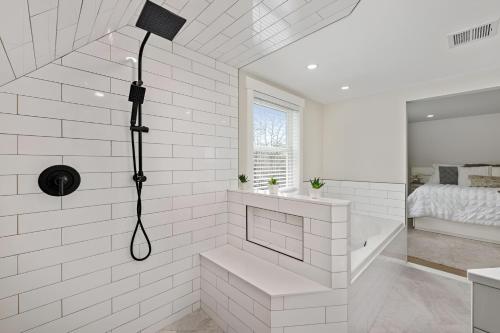 a white bathroom with a shower and a bed at Renovated & Sophisticated Home Near Beach & Shops! in Barnstable