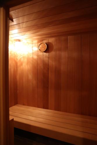 a sauna with a light on a wooden wall at EXP Co Onsen 呼隱撰 in Atami