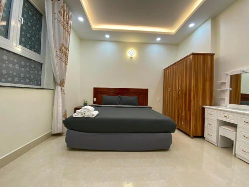 a bedroom with a large bed in a room at Da Quy Harmony Homestay in Da Lat