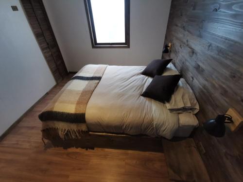 Ένα ή περισσότερα κρεβάτια σε δωμάτιο στο Hostal Licanantay
