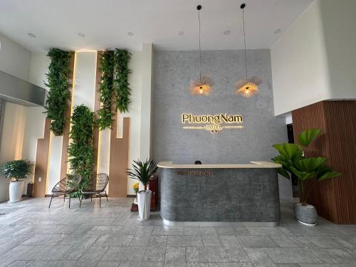 a lobby with a waiting room with plants on the wall at Phuong Nam Hotel An Giang in Long Xuyên