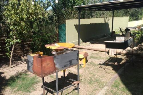 a backyard with a grill and a gazebo at Monoambiente amplio con pileta in Cosquín