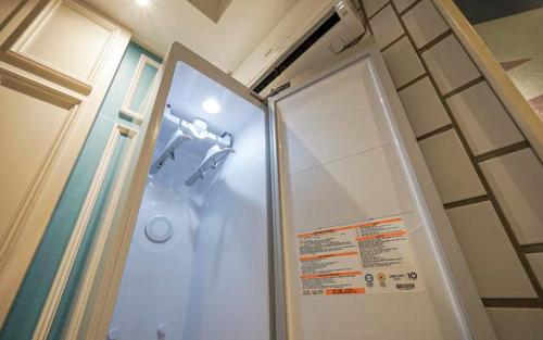 a shower in a bathroom with a glass door at B-Bas Hotel in Daegu