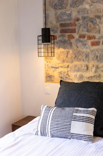 a bedroom with a bed with a stone wall at la chocolaterie in Roly