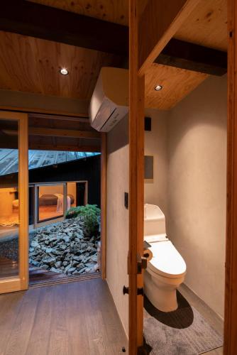 a bathroom with a toilet inside of a house at Contexted Boutique Villa in Osaka