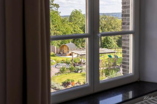 an open window looking out at a garden at la chocolaterie in Roly