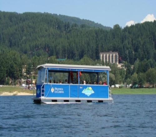 a blue bus in the water on a lake at San Lorenzo Si Alberga in Camigliatello Silano