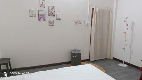 a bedroom with a bed and pictures on the wall at Homestay Mẹ Khang 2 in Cu Chi