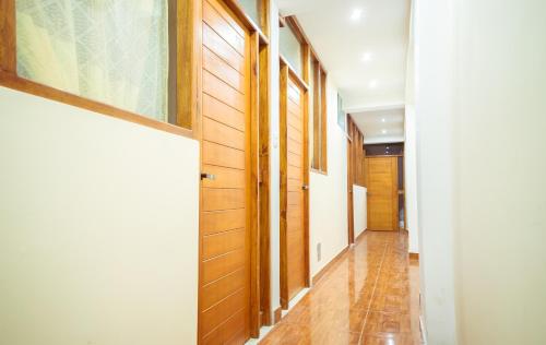 a hallway with wooden walls and a door at CASA ESTEVES in Ollantaytambo