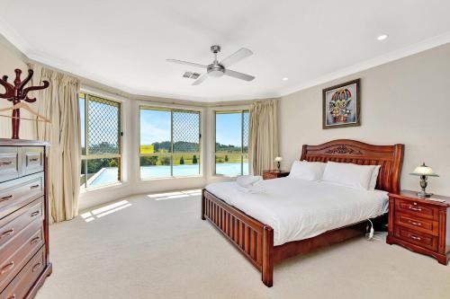 a bedroom with a bed and a large window at Noble Willow Estate in Lovedale